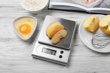Making Apple Pie. Using Digital Kitchen Scales On Wooden Table. Cooking Apple Cake Concept