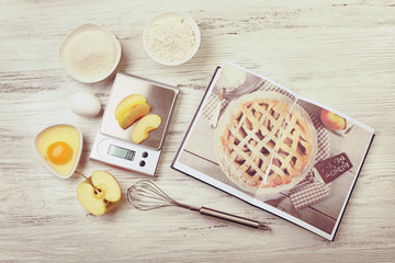 Wall Mural - Making apple pie. Using digital kitchen scales on wooden table. Cooking apple cake concept