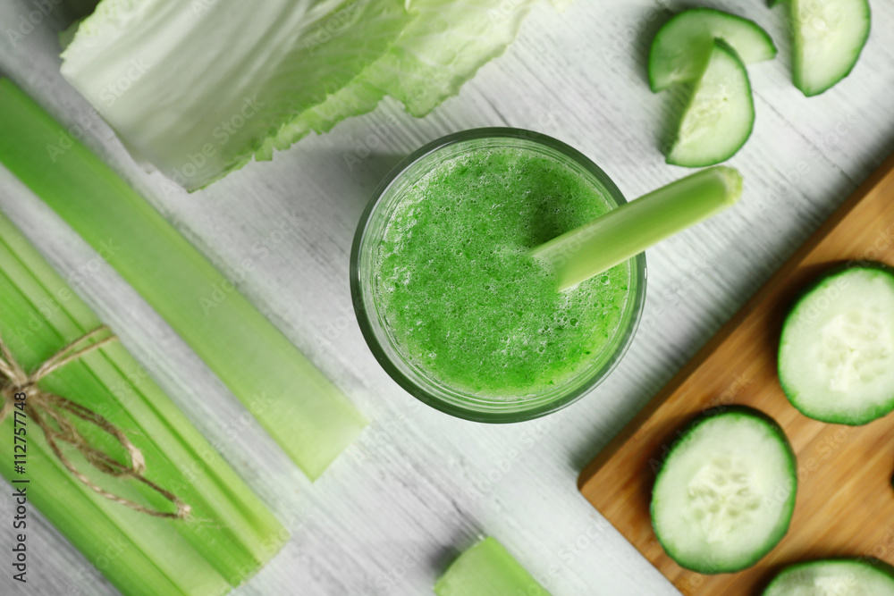 Fresh healthy vegetable smoothie with ingredients on wooden table