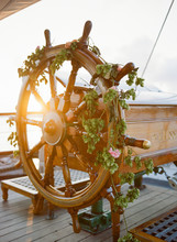 Steering Wheel On Ship Decorated With Flowers