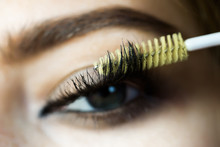 Female eye with mascara brush