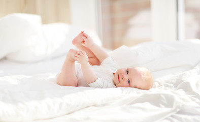 happy newborn baby on bed