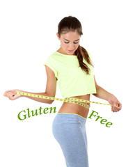 Young slim woman measuring her waist and text Gluten free isolated on white