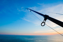 The Silhouette Of Fishing Poles Under Dramatic Sunset And Beautiful Sea