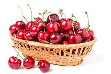 Wall Mural - cherries in a wicker basket isolated on white background