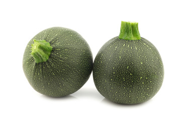 fresh round zucchini's on a white background