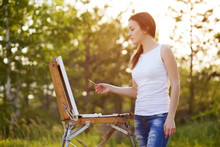 Young Lovely Caucasian Woman Painting Outdoors