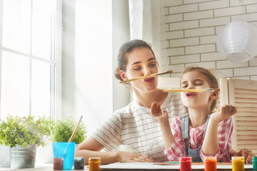 Mother and daughter together paint