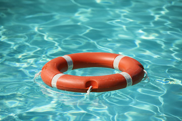 Lifesaver floating on water in swimming pool.