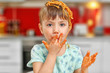 © Africa Studio - Adorable little girl eating spaghetti in kitchen