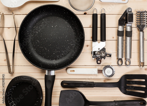 Fotomural cookware and accessories on a wooden table.