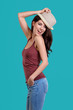© ZoomTeam - Woman wearing white straw hat on blue background