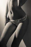 Fototapeta Sypialnia - image of beautiful sexy female in white lingerie over light background, black and white picture
