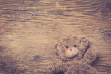 Brown Teddy Bear Over Wooden Background