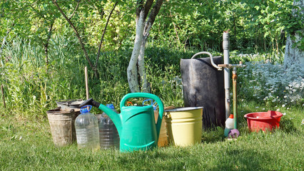  buckets and canisters with water in garden