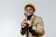 Afro amerian man singing into vintage microphone