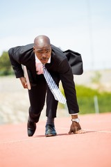 Wall Mural - Businessman with laptop ready to run