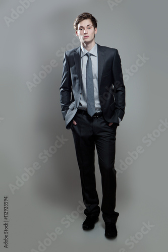 Fotografie, Obraz Serious young business man on gray background