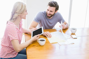Poster - Couple looking at each other while using digital tablet