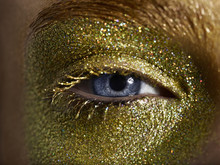 Close Up Of A Woman With Gold Eye Make Up