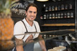 © Connect Images - Happy restaurateur behind service counter