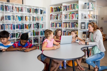 Teacher using technology with pupils