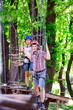 © davit85 - adventure climbing high wire park - people on course in mountain