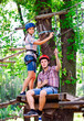 © davit85 - adventure climbing high wire park - people on course in mountain