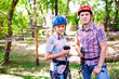 © davit85 - adventure climbing high wire park - people on course in mountain