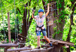 © davit85 - adventure climbing high wire park - people on course in mountain