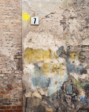 Colorful Abandoned Brick Wall And Plate With A Number Seven