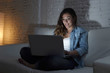 © Wordley Calvo Stock - attractive relaxed woman at home sitting happy on couch using laptop at night