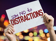 Say No To Distractions placard with night lights on background