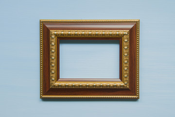 Wooden picture frame on a blue background.