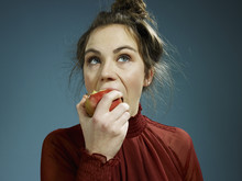 A Young Hip Woman Eating An Apple