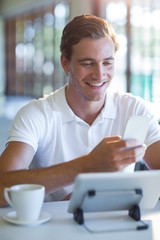 Poster - Smiling man using mobile phone