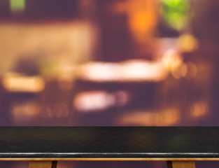 Poster - Empty black marble table and blurred cafe bokeh light background