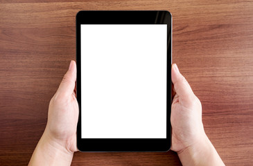 Poster - top view of two hand holding tablet with blank white screen on d