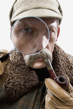 A Man Dressed Up As Sherlock Holmes With A Magnifying Glass Distorting His Eye