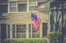 American Flag In Front Of Typical American House