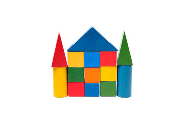 House made of old cubes. Wooden colorful building blocks isolated on white background. Vintage childrens toys.