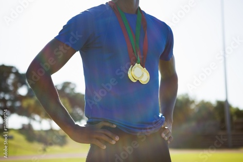 Mid section of athlete posing with gold medal after victory Poster