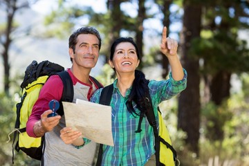 Poster - Couple pointing and holding a map 
