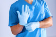 © lenetsnikolai - The surgeon wears gloves before surgery. Close-up