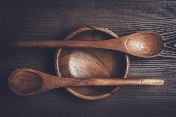 Wall Mural - empty salad bowl and two spoons on wooden table