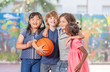 © jovannig - Group of mixed race children playing basketball in school courty