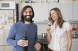 © fStop - Happy couple enjoying red wine in kitchen