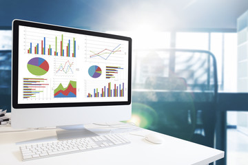 Poster - Modern computer with keyboard and mouse on table showing charts