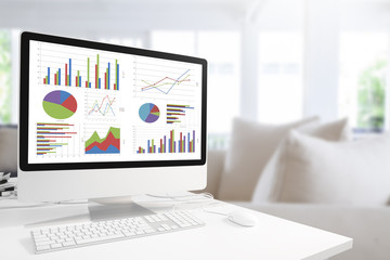 Poster - Modern computer with keyboard and mouse on table showing charts