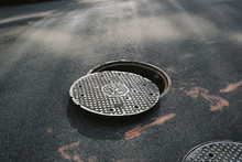 A Manhole Cover Partially Removed, Close-up